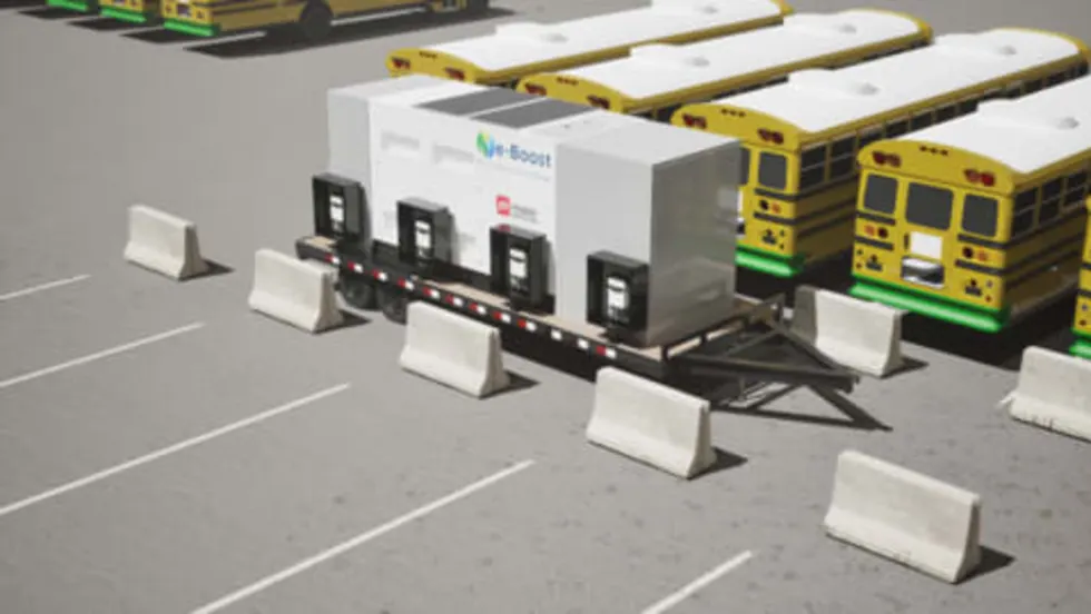 Mobile EV charging trailer with multiple charging units parked at a school bus depot, supporting electric school buses with flexible, high-capacity overnight charging.
