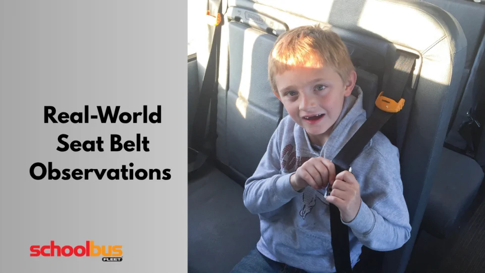 a child sits on a school bus seat wearing a seat belt