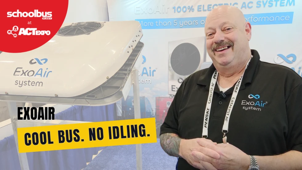 Jeff Weiss of ExoAir Systems stands beside a roof-mounted electric air conditioning unit at ACT Expo. Text overlay reads “ExoAir: Cool Bus. No Idling.” 