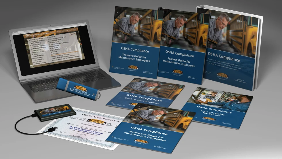 OSHA compliance training materials for school bus technicians and drivers, including manuals, USB drive, certificate, and laptop displaying course content.