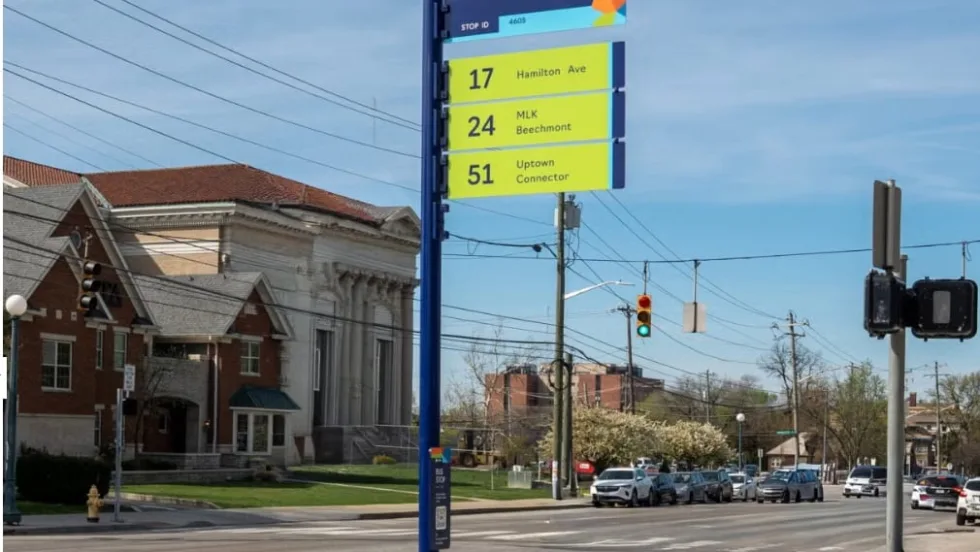 New Cincinnati Metro bus stop sign with large route numbers and clear layout at a city intersection, part of a systemwide signage upgrade initiative.