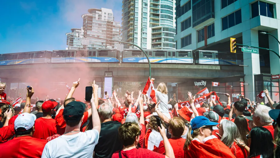 Canada-Qatar match fans underneath a TransLink SkyTrain overpass.