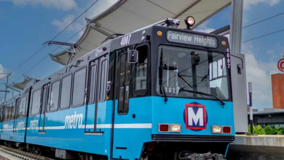 A rendering of a light blue Metro Transit rail car at a station.