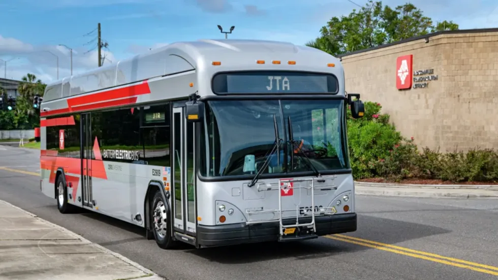 A Jacksonville Transportation Authority bus driving on a road.