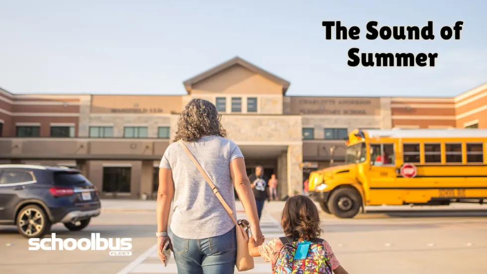 Parent and child walk toward an elementary school at pickup time while a yellow school bus waits outside, alongside the headline “The Sound of Summer.”