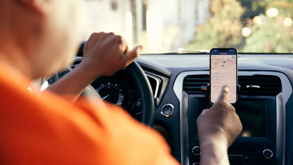 A HopSkipDrive CareDriver uses a mobile navigation app.