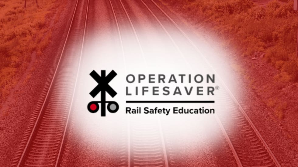 Operation Lifesaver Rail Safety Education logo over railroad tracks background, representing rail safety awareness initiatives.