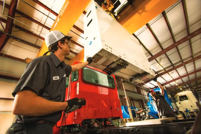 A Rush Enterprises technician installs a back-of-cab compressed natural gas system.
