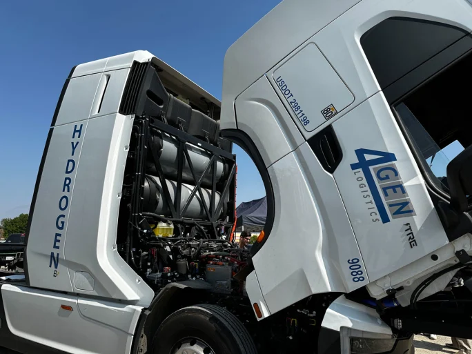 White Nikola hydrogen fuel cell truck with cab tipped to reveal engine