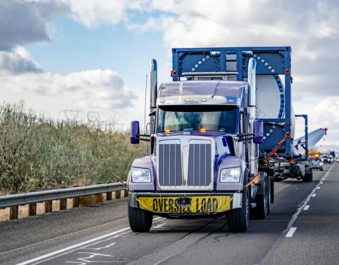 Photo of truck hauling a wind turbine blade with