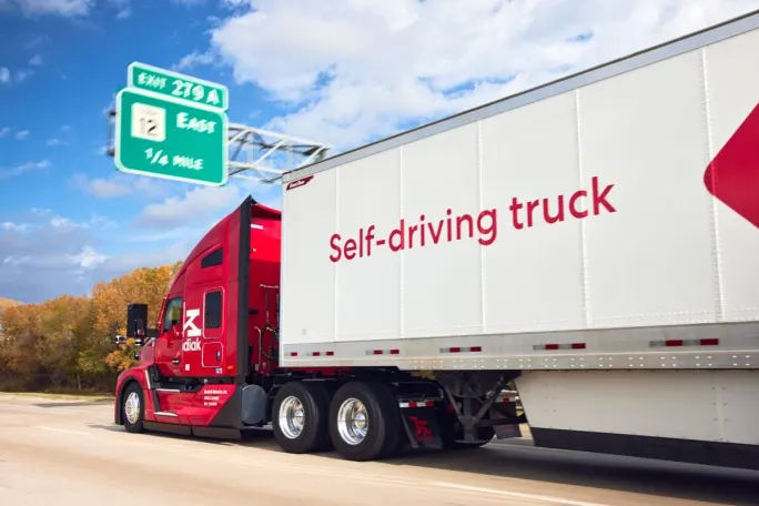 Red Kodiak autonomous truck pulling trailer that says