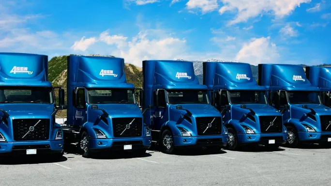 Line of blue electric Volvo VNR tractors