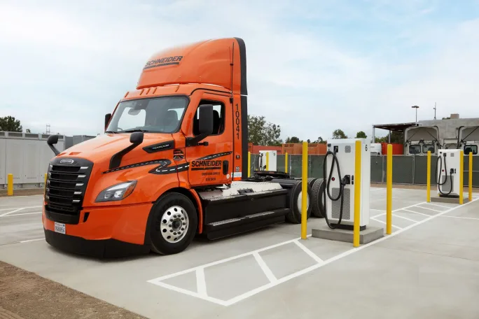 Orange electric Schneider eCascadia at charging station