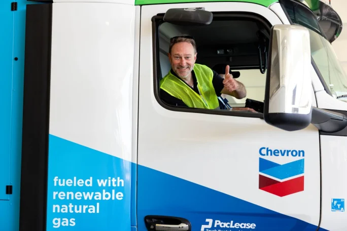 Man in cab of big rig with a thumbs-up