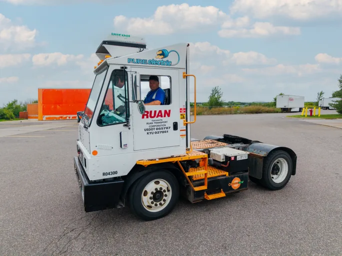 Electric yard tractor with Ruan name on door