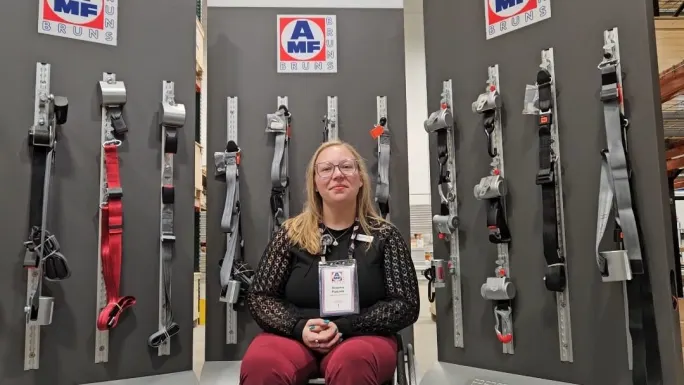 brianna pauwee sits in front of a product display