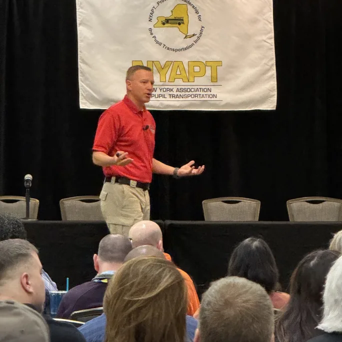 Bret Brooks of Gray Ram Tactical speaks to school transportation professionals during a training session at the New York Association for Pupil Transportation conference.