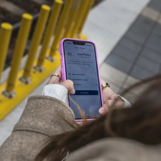 A person holding a mobile phone.