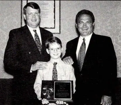 Kellie Dean of Dean Transportation accepts the School Bus Fleet 1995 Contractor of the Year award, standing with SBF Publisher Frank Di Giacomo and Dean’s son Patrick at the NSTA convention.