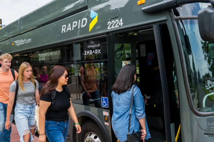 Passengers boarding an EMBARK BRT bus.