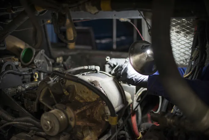 Maintenance worker performing engine work