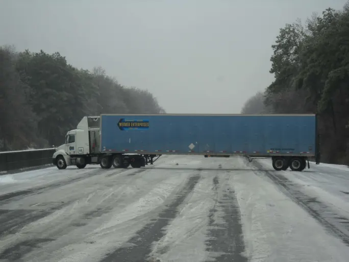 Jack-knifed tractor-trailer.