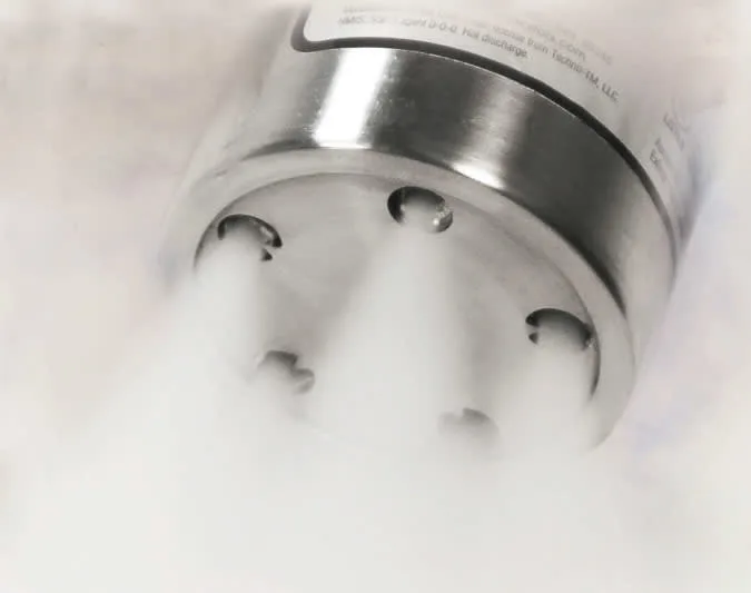 Close-up of a fire suppression system component releasing extinguishing agent.