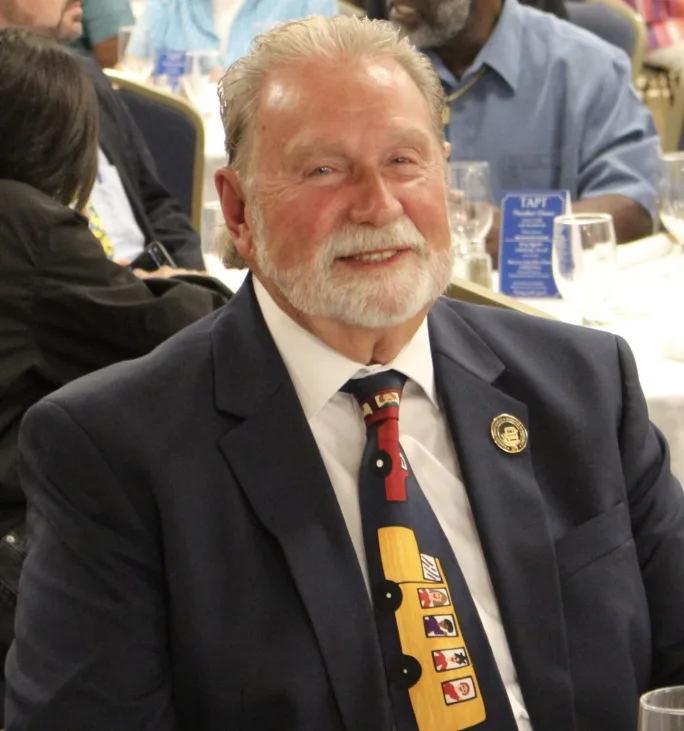 Jerry Green sits at a table at an awards ceremony