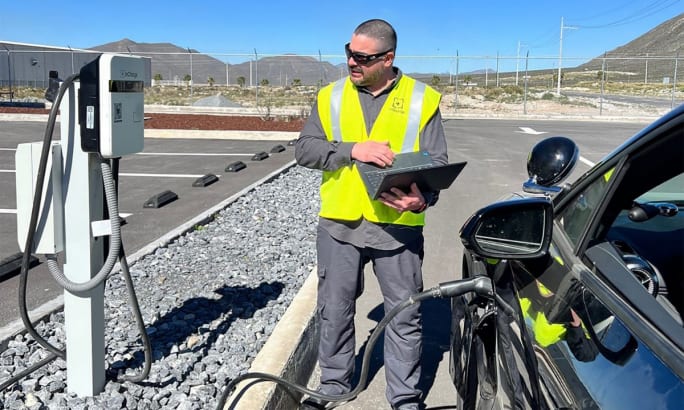 An InCharge Energy technician working on an EV charger.