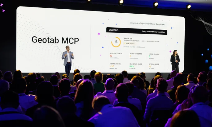 Geotab professionals standing on a stage in front of a crowd.
