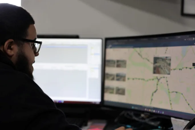 Man sitting in front of computer screens