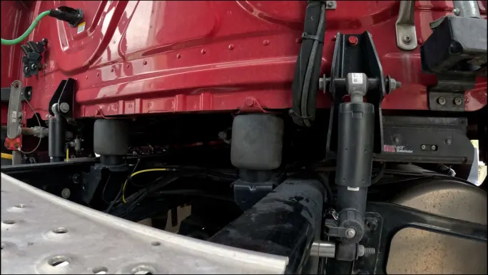 Photo showing air springs and ROI Cabmate suspension system under truck cab from rear