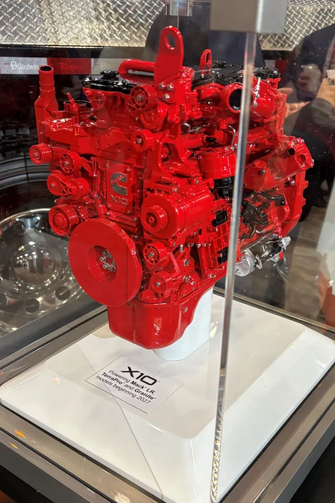 Miniature red engine in a display case at Mack's ACT Expo booth