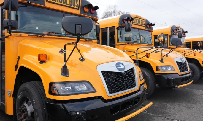A lineup of Blue Bird propane school buses.