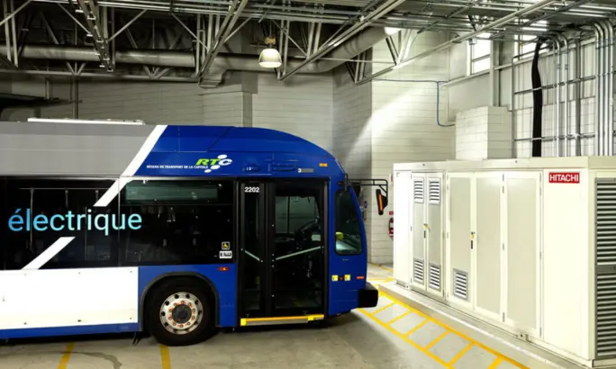 A Canadian public transit bus near Hitachi Energy infrastructure.