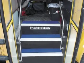 Safeguard Technology's step cover wraps over the leading edge of bus stairs for anti-slip protection.