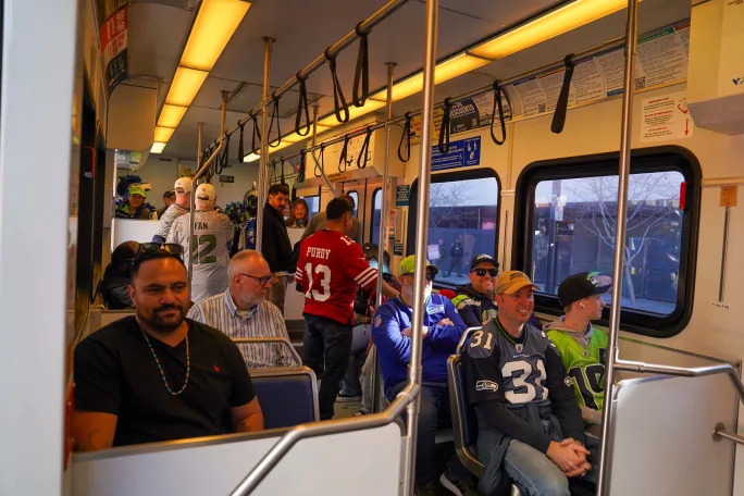 Football fans on VTA light rail vehicle.