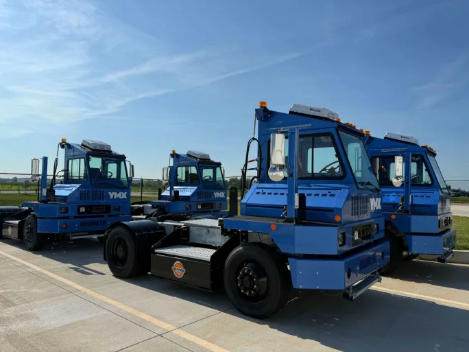 Four blue electric yard tractors
