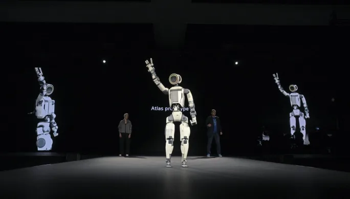 Atlas humanoid robot waves to crowd from stage at CES 2026