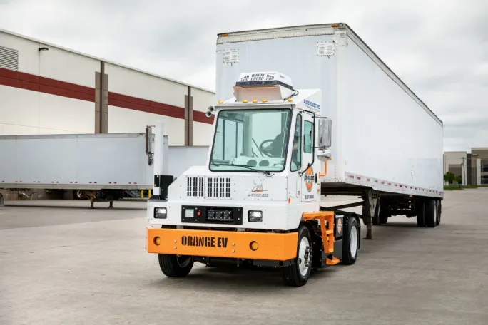 Orange EV terminal tractor. 