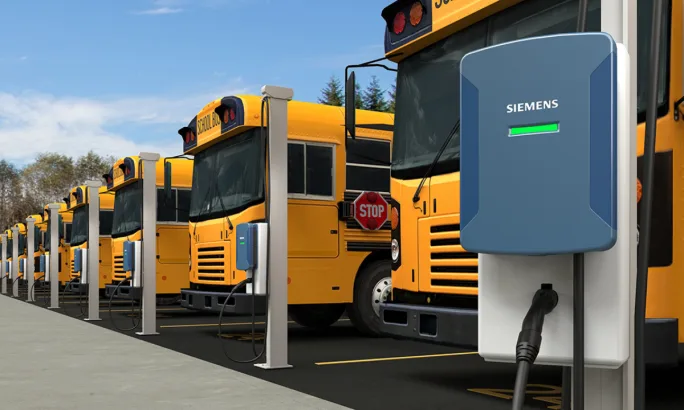A rendering of a Heliox, a Siemens business, charging in front of school buses.