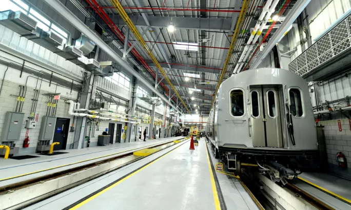 Interior view of the Railcar Acceptance and Testing Facility with a railcar on the right-side track.