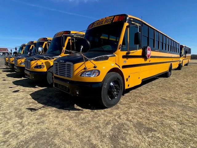 a row of school buses outside
