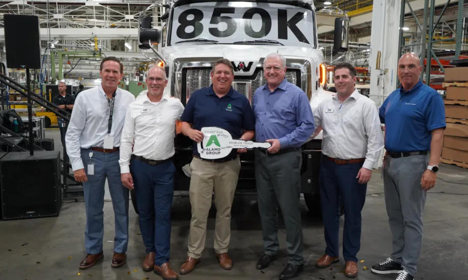 Six men stand in front of a Western Star truck marked “850K” at DTNA’s Cleveland plant, holding a ceremonial key for the 850,000th truck delivered to Alamo Group for snow and ice operations.