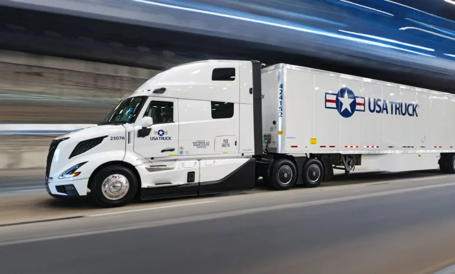 USA Truck branded tractor-trailer on road with blurred background effect