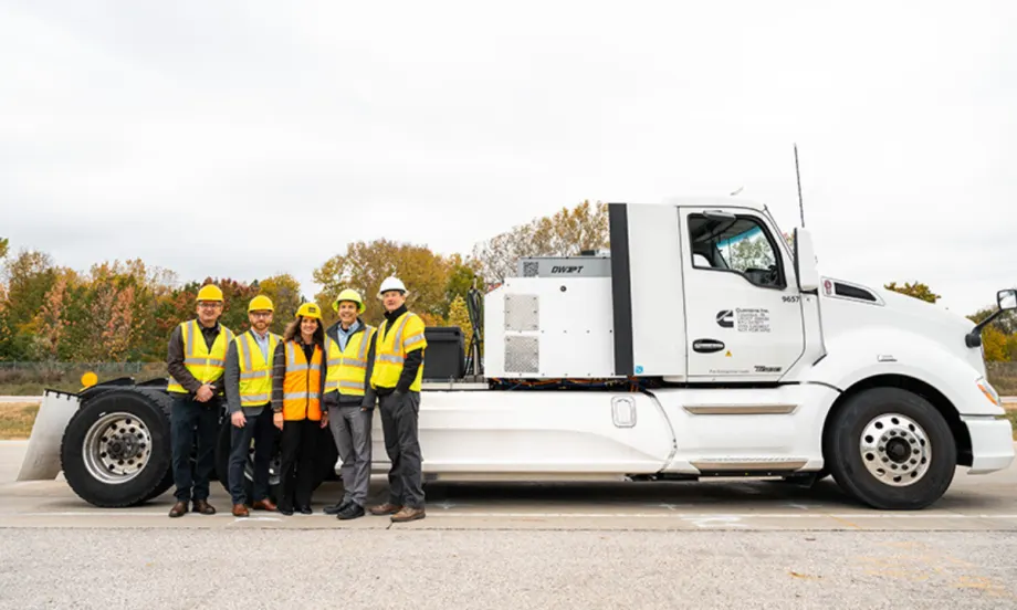 Group of researchers and engineers standing next to an electric heavy-duty truck used in Purdue’s wireless charging project.