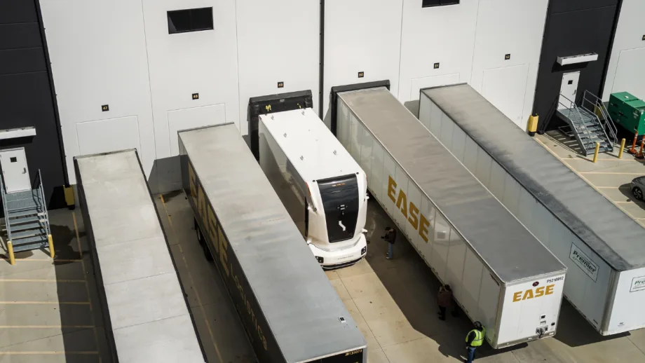 Overhead view of an Einride autonomous electric truck positioned between trailers at an EASE Logistics warehouse loading area in Marysville, Ohio.
