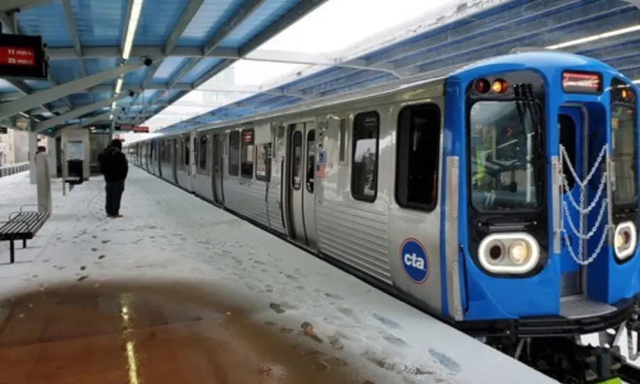 A Chicago Transit Authority 7000-series railcar at a snowy station.