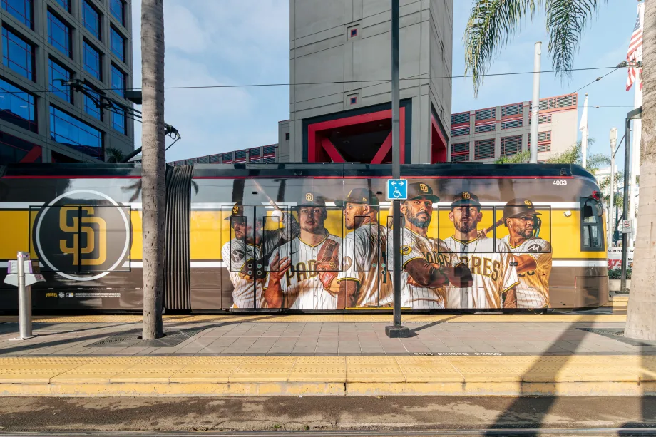 A San Diego Metropolitan Transit System trolley wrapped with a Padres player advertisement.