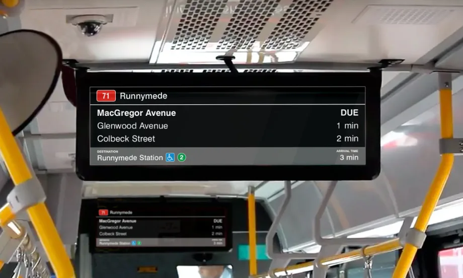 New digital signage attached to the ceiling of a TTC bus.